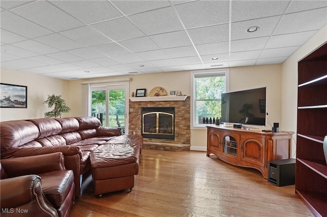 1288 Windward Ln, Kent, OH 44240 - living room featuring a paneled ceiling, healthy amount of natural light, a glass covered fireplace, and hardwood / wood-style floors