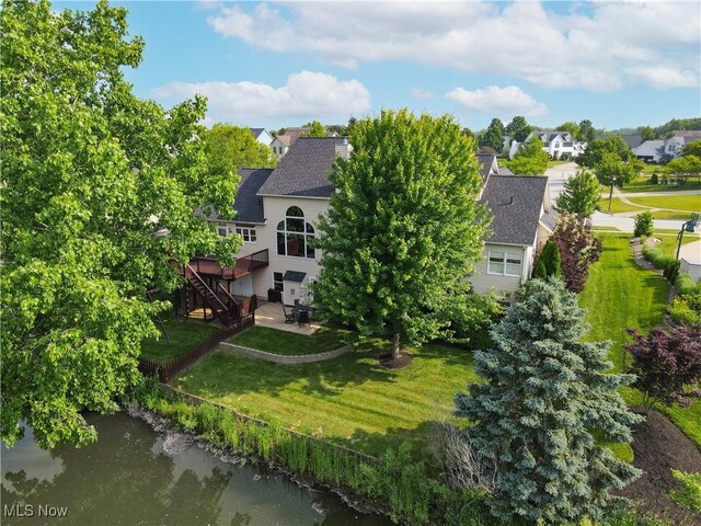 1288 Windward Ln, Kent, OH 44240 - back of house featuring stairway, a deck with water view, a lawn, a patio area, and a residential view
