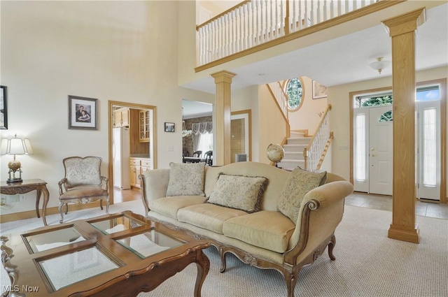 1288 Windward Ln, Kent, OH 44240 - living area featuring ornate columns, stairway, light carpet, and a towering ceiling