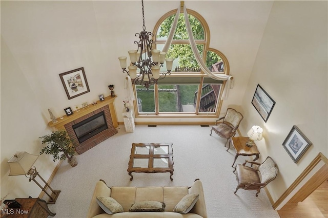1288 Windward Ln, Kent, OH 44240 - living area with a chandelier, a fireplace, a towering ceiling, and carpet floors