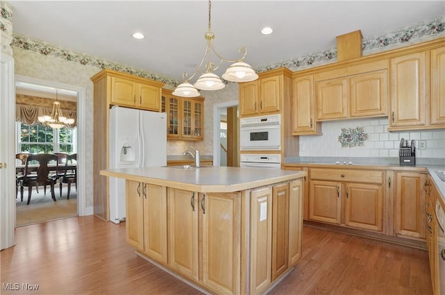 1288 Windward Ln, Kent, OH 44240 - kitchen featuring a chandelier, white appliances, wood finished floors, a center island with sink, and light countertops