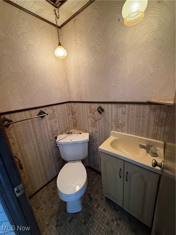522 N 3rd St, Toronto, OH 43964 - half bath with wallpapered walls, vanity, and a wainscoted wall