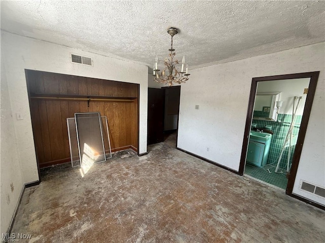 522 N 3rd St, Toronto, OH 43964 - unfurnished dining area with a chandelier and a textured ceiling