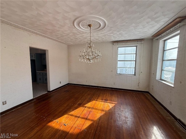 522 N 3rd St, Toronto, OH 43964 - spare room with a chandelier, wood-type flooring, and a textured wall
