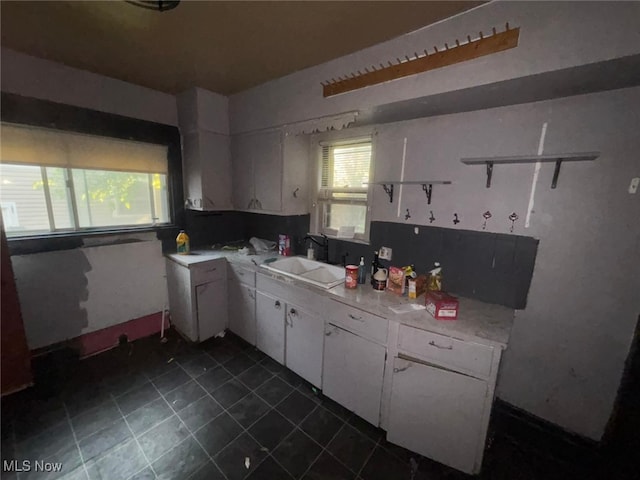 1395 Goodyear Blvd, Akron, OH 44305 - kitchen with open shelves, white cabinets, plenty of natural light, and dark tile patterned floors