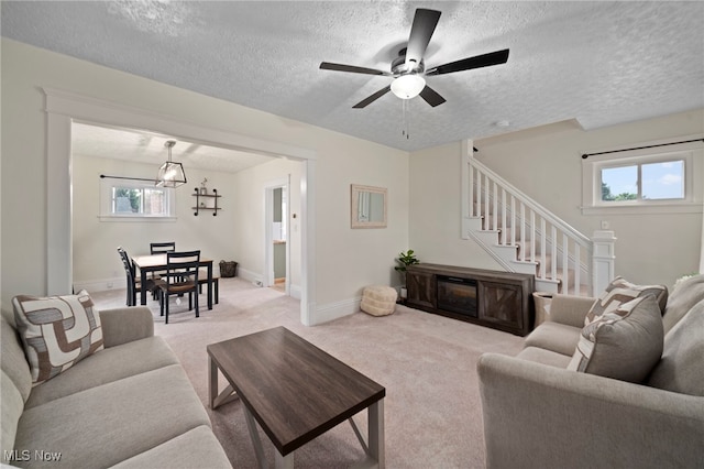 326 N Park Ave, Alliance, OH 44601 - living area with plenty of natural light, a textured ceiling, light carpet, ceiling fan, and stairs