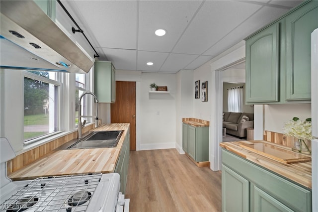 326 N Park Ave, Alliance, OH 44601 - kitchen featuring green cabinets, wood counters, recessed lighting, stove, and light wood-type flooring