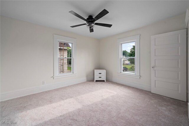 326 N Park Ave, Alliance, OH 44601 - spare room with healthy amount of natural light, carpet floors, and a ceiling fan