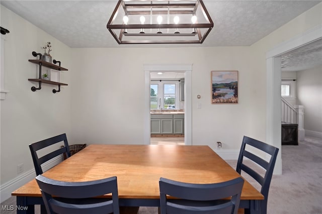 326 N Park Ave, Alliance, OH 44601 - carpeted dining room with a textured ceiling and stairs