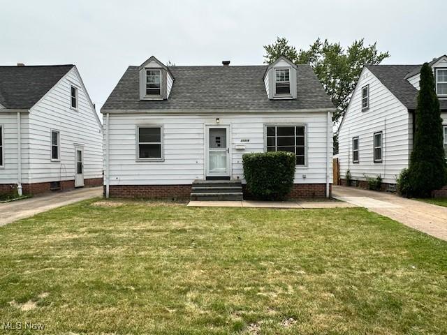 21316 Watson Rd, Maple Heights, OH 44137 - cape cod-style house with a front lawn and a shingled roof