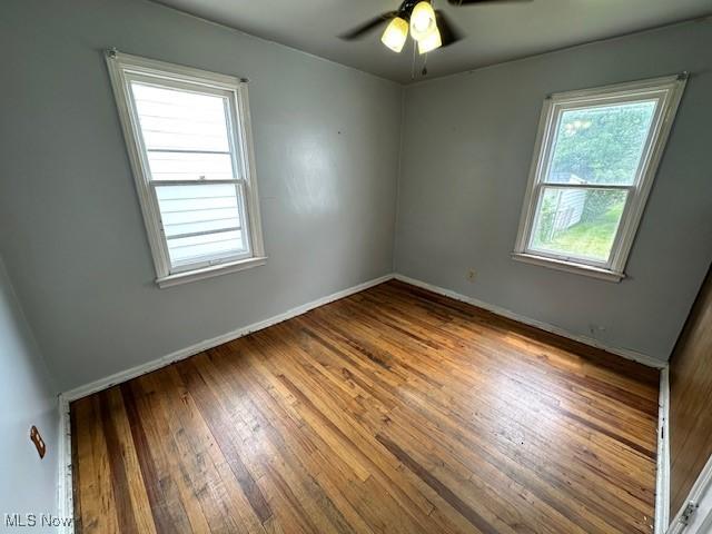 21316 Watson Rd, Maple Heights, OH 44137 - unfurnished room with wood-type flooring and ceiling fan