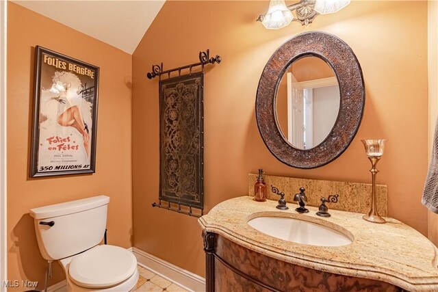 7488 Valley View Rd, Hudson, OH 44236 - half bath featuring vanity, lofted ceiling, tile patterned flooring, and a chandelier