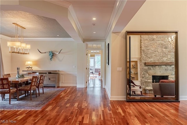 7488 Valley View Rd, Hudson, OH 44236 - dining space featuring wood finished floors, ornamental molding, a chandelier, and a fireplace