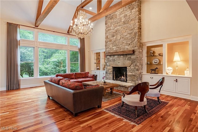 7488 Valley View Rd, Hudson, OH 44236 - living area with high vaulted ceiling, light wood-style floors, a chandelier, beamed ceiling, and a fireplace