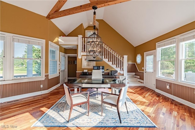 7488 Valley View Rd, Hudson, OH 44236 - dining room with stairway, wood finished floors, high vaulted ceiling, and a wainscoted wall