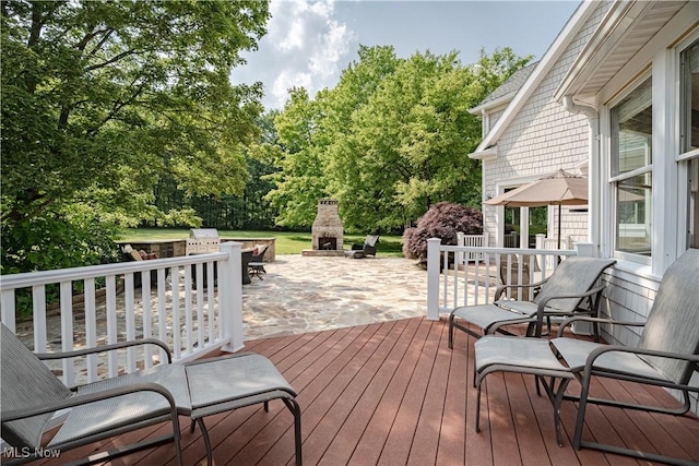 7488 Valley View Rd, Hudson, OH 44236 - wooden terrace featuring exterior fireplace, a patio, and view of wooded area