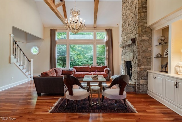 7488 Valley View Rd, Hudson, OH 44236 - living area featuring wood finished floors, a chandelier, stairway, high vaulted ceiling, and a stone fireplace