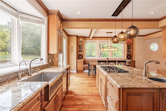 7488 Valley View Rd, Hudson, OH 44236 - kitchen with stainless steel gas cooktop, light wood-style flooring, tasteful backsplash, pendant lighting, and brown cabinetry