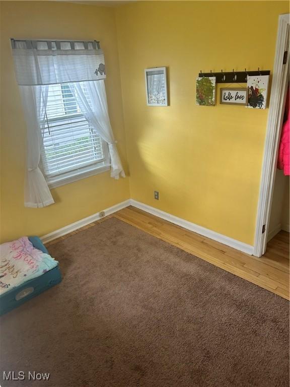 7438 Westview Dr, Youngstown, OH 44512 - spare room with baseboards and wood finished floors