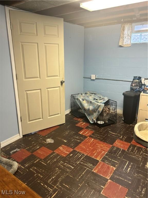 7438 Westview Dr, Youngstown, OH 44512 - bedroom with concrete block wall and tile patterned floors