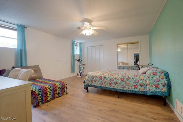 1701 19th Ave, Parkersburg, WV 26101 - bedroom featuring multiple windows, multiple closets, light wood-style flooring, and ceiling fan