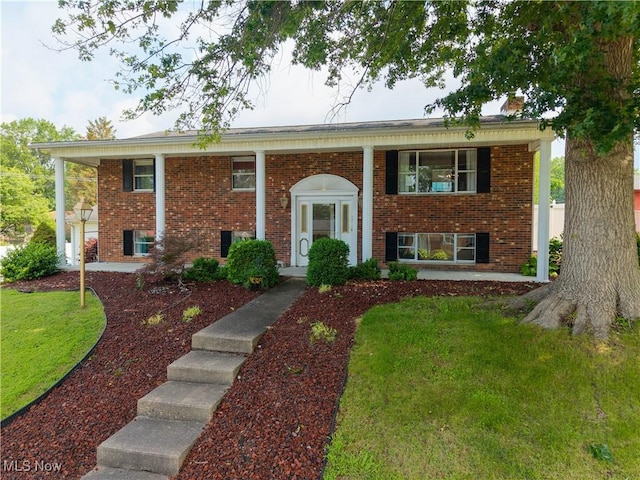 1701 19th Ave, Parkersburg, WV 26101 - split foyer home with a front lawn, brick siding, and covered porch