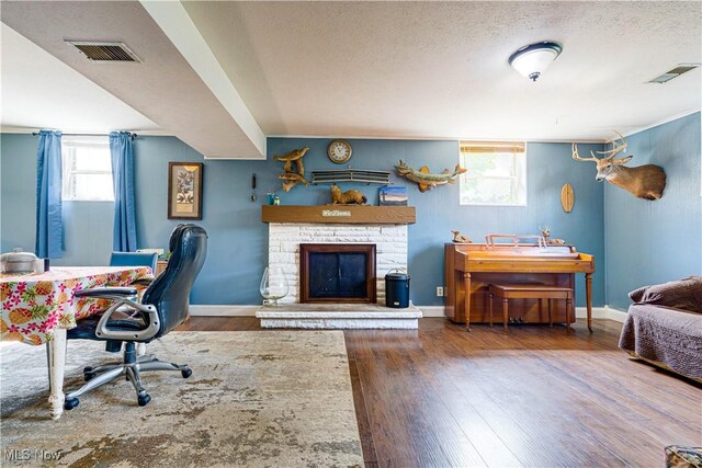 1701 19th Ave, Parkersburg, WV 26101 - office featuring wood finished floors, a textured ceiling, and a stone fireplace