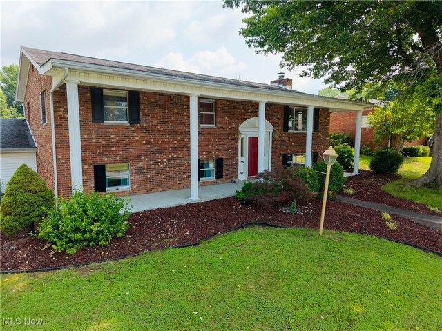 1701 19th Ave, Parkersburg, WV 26101 - bi-level home featuring a front lawn, brick siding, and a chimney