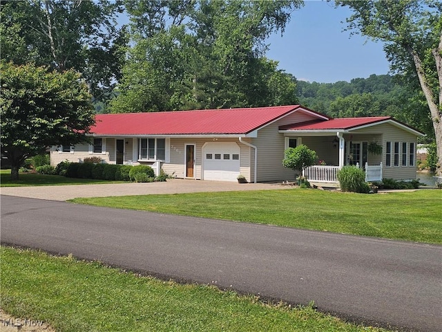 7261 Austin Dr, Mcconnelsville, OH 43756 - ranch-style house featuring an attached garage, driveway, a porch, a front lawn, and a metal roof
