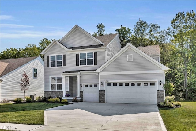 23200 St Andrews Dr, Columbia Station, OH 44028 - traditional-style house with driveway, a garage, a front lawn, roof with shingles, and stone siding