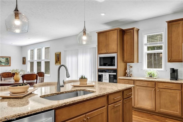 23200 St Andrews Dr, Columbia Station, OH 44028 - kitchen featuring appliances with stainless steel finishes, pendant lighting, and brown cabinetry