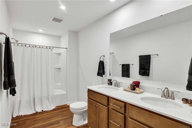 23200 St Andrews Dr, Columbia Station, OH 44028 - bathroom featuring double vanity, wood finished floors, shower / bath combo with shower curtain, and recessed lighting