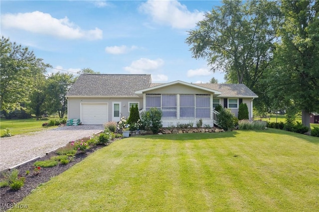 14203 Hatfield Rd, Rittman, OH 44270 - view of front of home with an attached garage, gravel driveway, a front yard, a sunroom, and a shingled roof