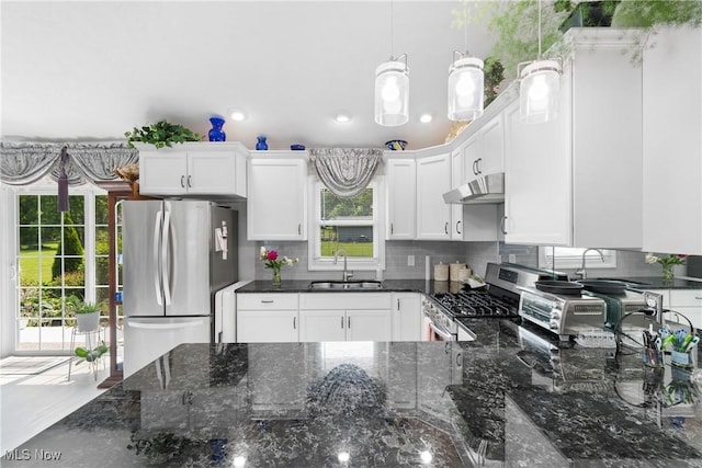 14203 Hatfield Rd, Rittman, OH 44270 - kitchen featuring stainless steel appliances, under cabinet range hood, decorative backsplash, white cabinets, and recessed lighting
