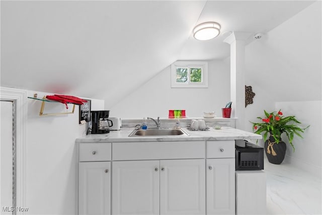 14203 Hatfield Rd, Rittman, OH 44270 - kitchen featuring white cabinetry, lofted ceiling, light countertops, marble look tiles, and black microwave
