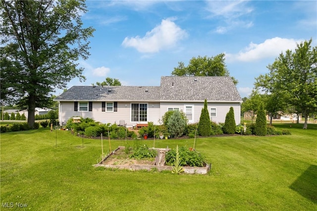 14203 Hatfield Rd, Rittman, OH 44270 - rear view of house featuring a garden and a lawn