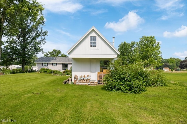 14203 Hatfield Rd, Rittman, OH 44270 - rear view of property with a yard and board and batten siding