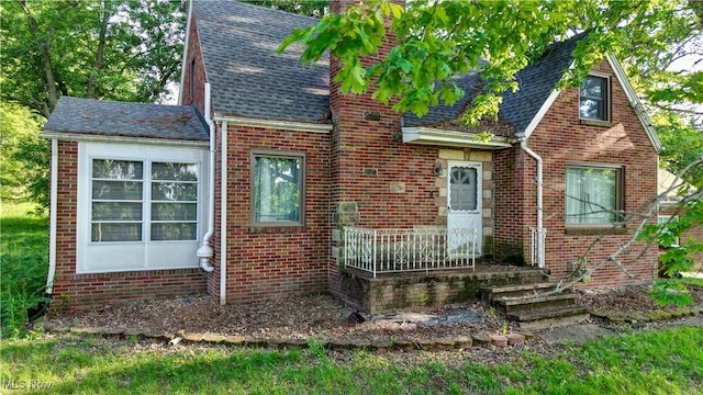 2335 Southway St SW, Massillon, OH 44646 - english style home featuring brick siding, a shingled roof, and a chimney