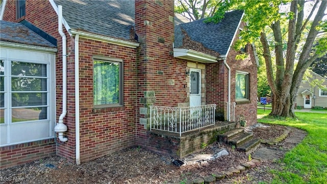 2335 Southway St SW, Massillon, OH 44646 - view of side of home with brick siding, a chimney, and roof with shingles