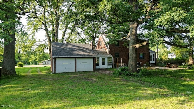 2335 Southway St SW, Massillon, OH 44646 - back of house featuring a garage and a yard
