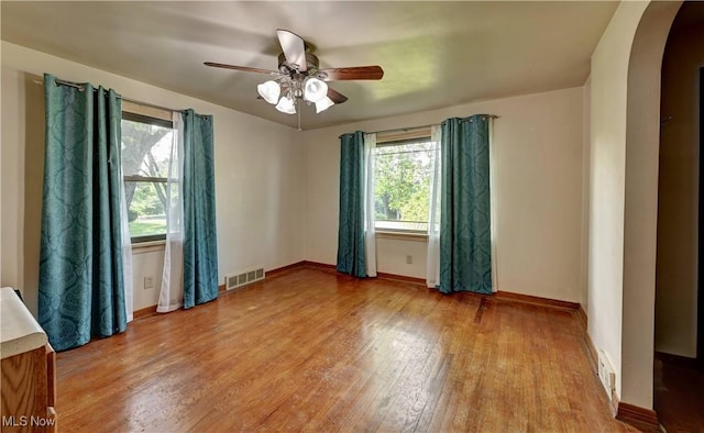 2335 Southway St SW, Massillon, OH 44646 - spare room with arched walkways, wood finished floors, healthy amount of natural light, and ceiling fan