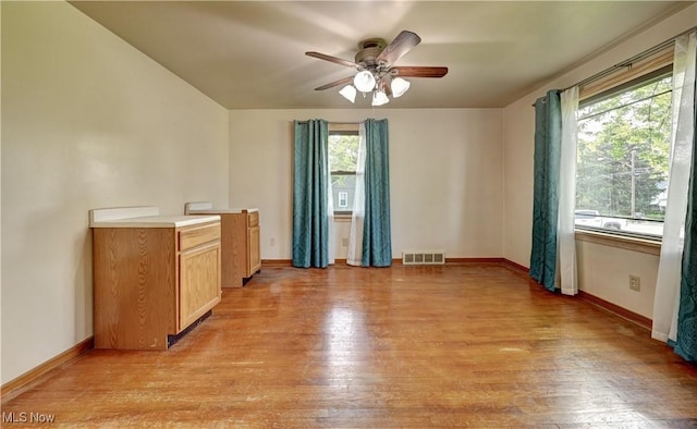 2335 Southway St SW, Massillon, OH 44646 - unfurnished living room featuring healthy amount of natural light, light wood-type flooring, and ceiling fan