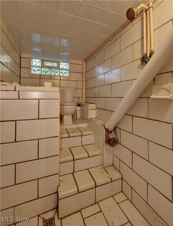 2335 Southway St SW, Massillon, OH 44646 - bathroom featuring toilet and tile walls