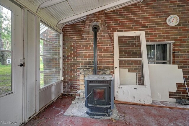 2335 Southway St SW, Massillon, OH 44646 - unfurnished sunroom featuring a wood stove and lofted ceiling