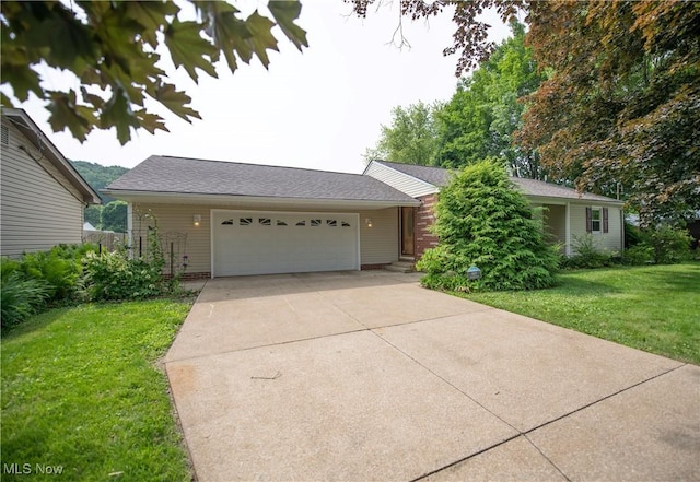 809 Mcdaniel Ave, Minerva, OH 44657 - ranch-style house featuring a front lawn, an attached garage, roof with shingles, and driveway