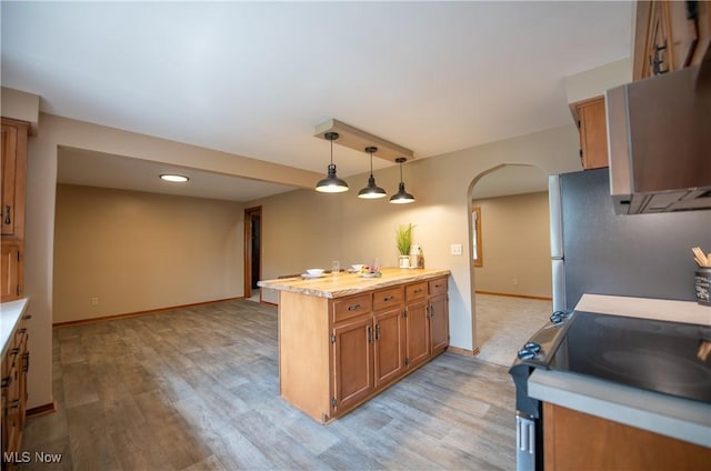 809 Mcdaniel Ave, Minerva, OH 44657 - kitchen with arched walkways, appliances with stainless steel finishes, light countertops, light wood-style floors, and recessed lighting