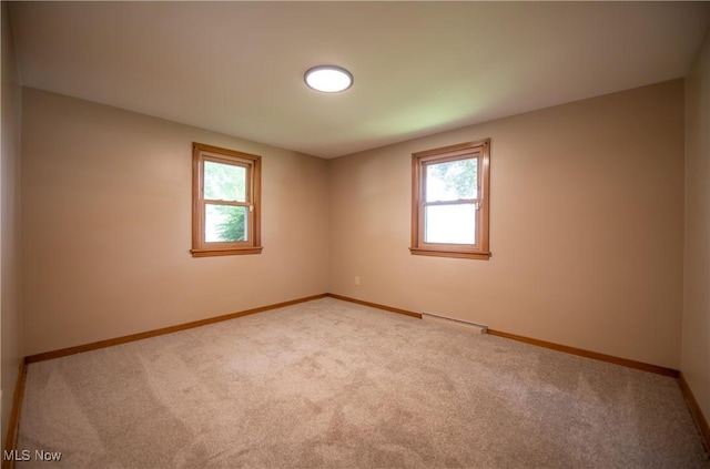 809 Mcdaniel Ave, Minerva, OH 44657 - unfurnished room with healthy amount of natural light and light colored carpet