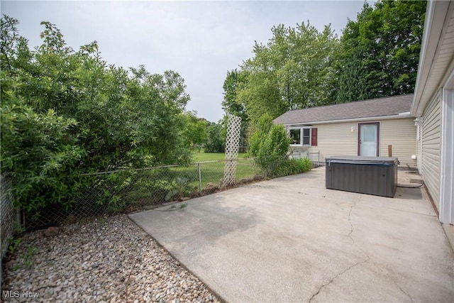 809 Mcdaniel Ave, Minerva, OH 44657 - fenced backyard featuring a hot tub and a patio area