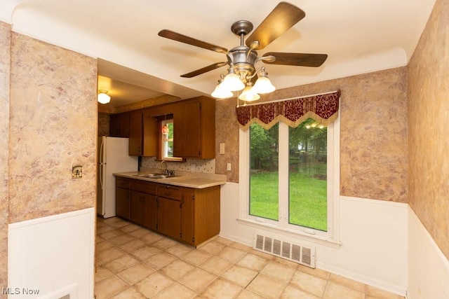 1114 W Miner Rd, Mayfield Heights, OH 44124 - kitchen featuring light countertops, ceiling fan, freestanding refrigerator, and brown cabinets