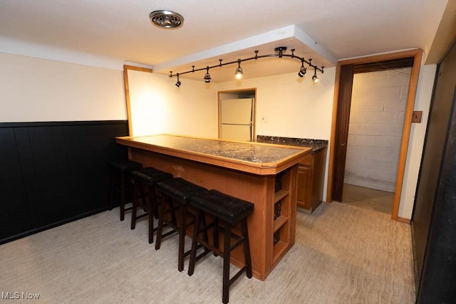 1114 W Miner Rd, Mayfield Heights, OH 44124 - kitchen with paneled built in refrigerator, a breakfast bar, open shelves, brown cabinetry, and dark countertops